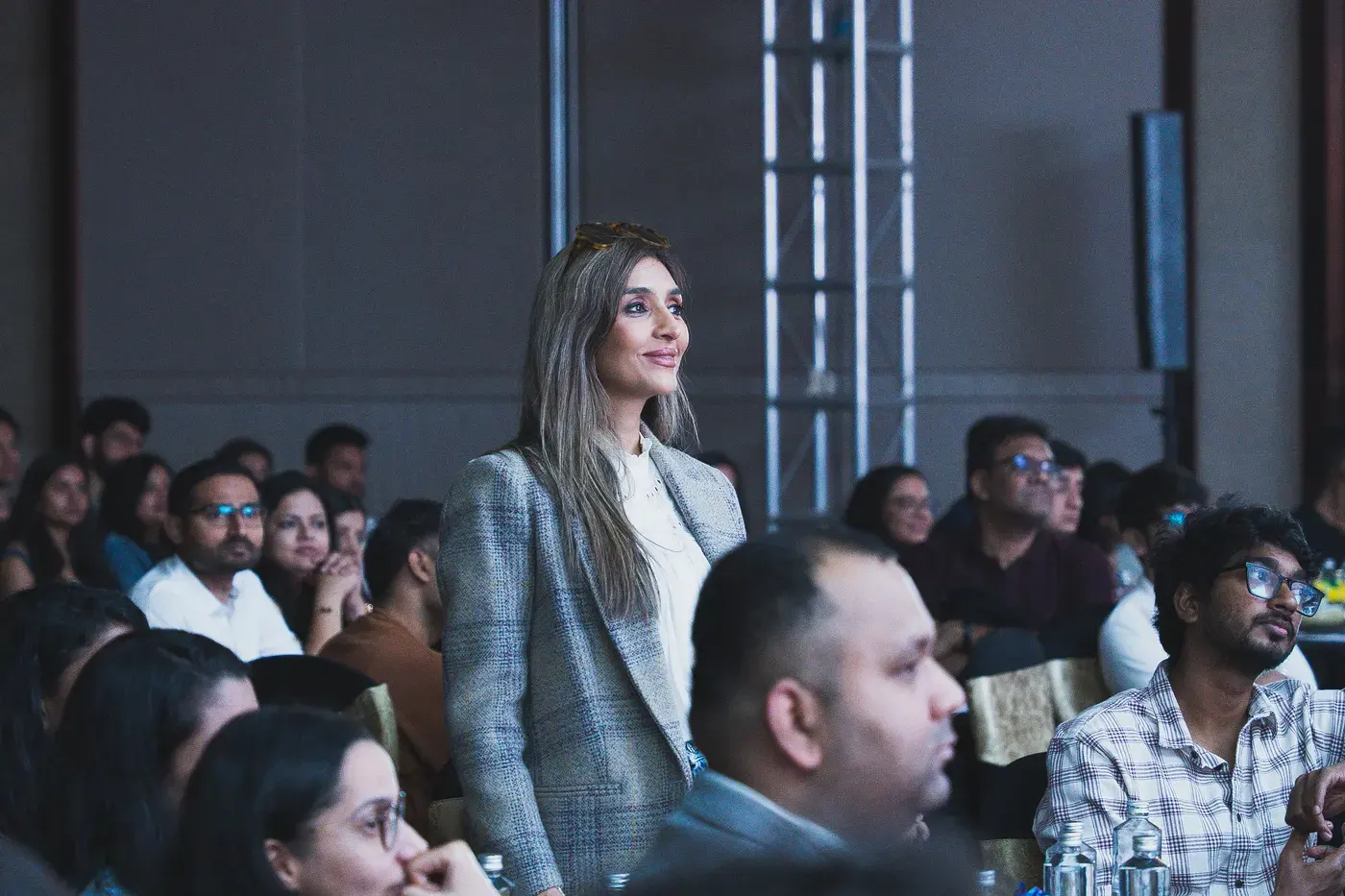 A guest standing to be recognised among the seated audience