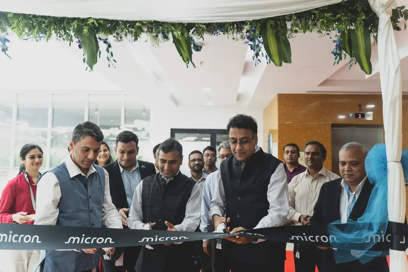 Leadership cutting a branded ribbon at the opening of a new facility